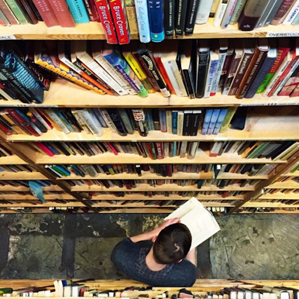 A bird’s eye view angle of a boy reading in a library