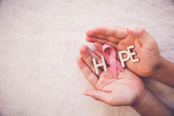 Open hands with the word, HOPE, and a pink ribbon as the “O.”
