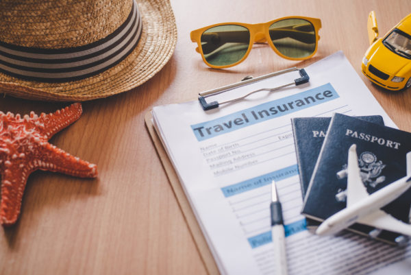Passports and travel insurance documents on a table before a vacation
