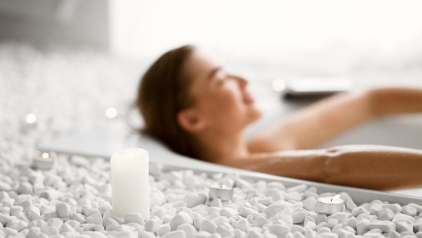 A woman relaxes in a luxurious bathtub