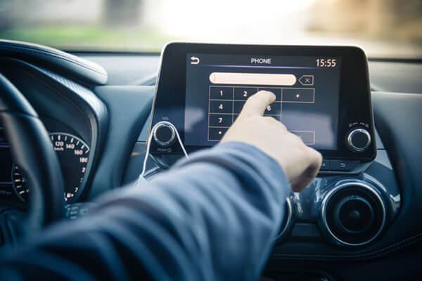 A man using a vehicle's infotainment system
