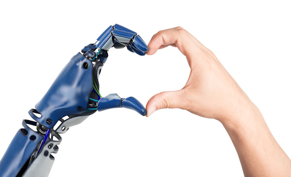 A robot and human hand make a heart